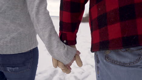 slow motion close up of couple ice skating hand in hand