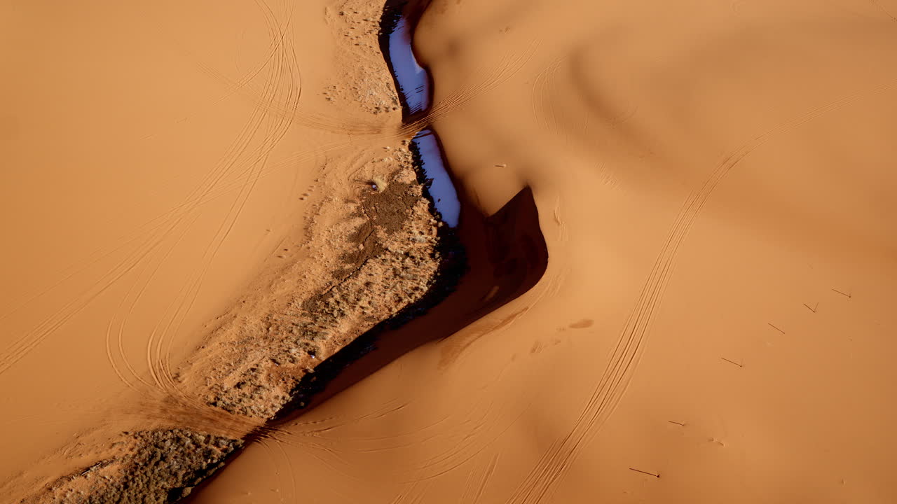 Surreal overhead drone footage showcasing the artistic curves of Utah’s pink desert landscape.