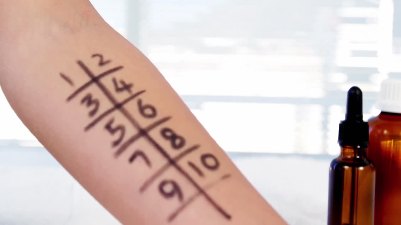 доктор держит капсулу с лекарством над рукой пациента с сеткой номеров