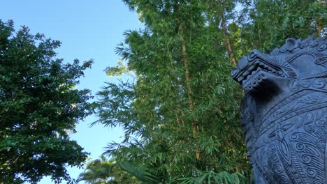 statue amidst trees and bamboo at australia zoo