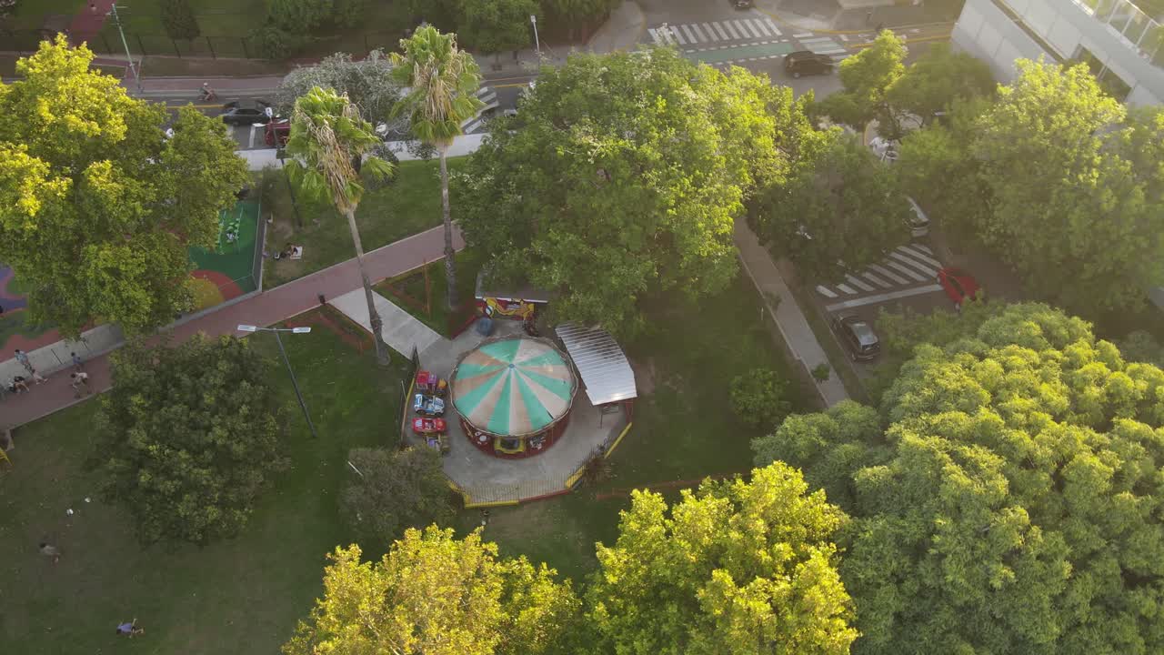 Spinning carousel at the children's park in Buenos Aires City, overhead aerial