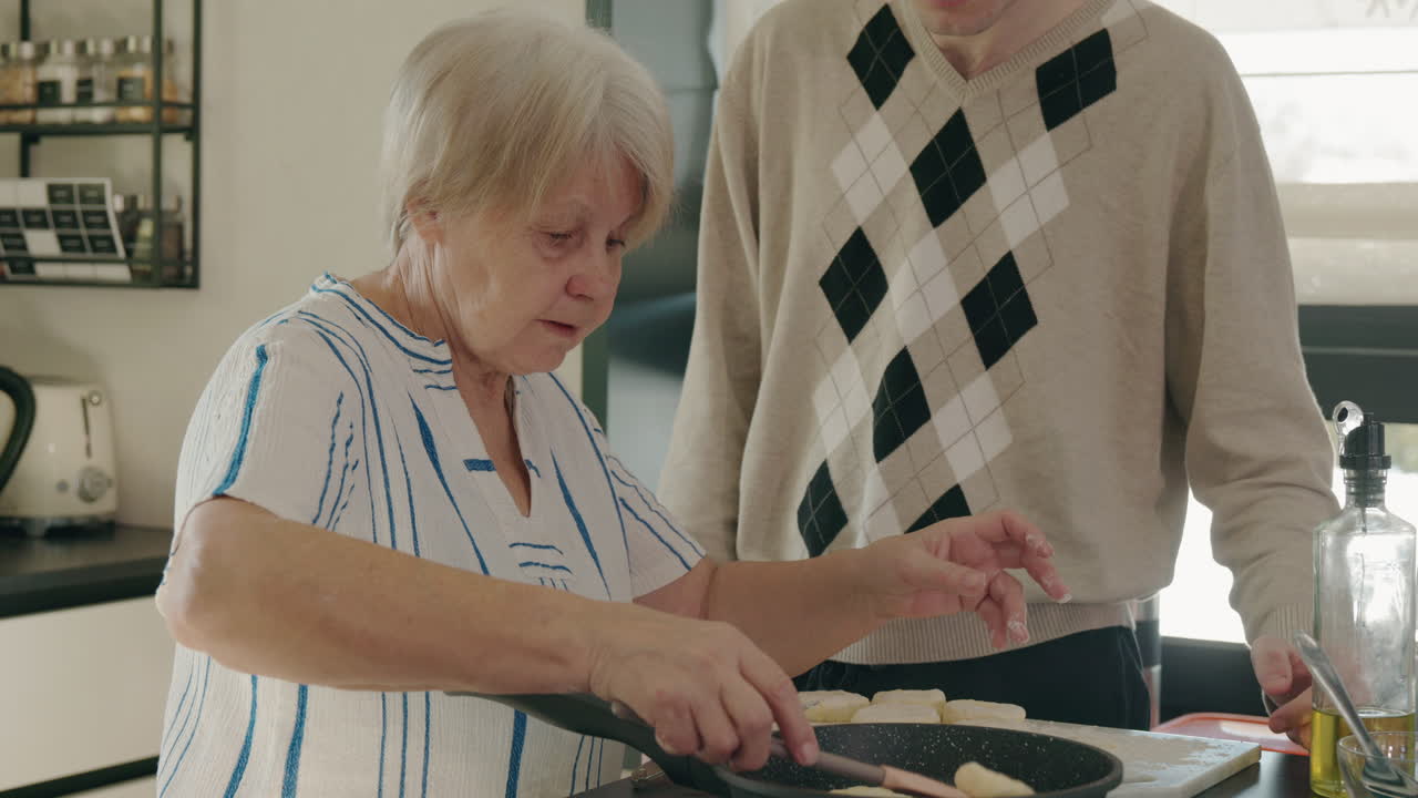 Elderly Woman and Grandson Cooking Together