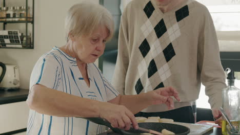elderly woman and grandson cooking together