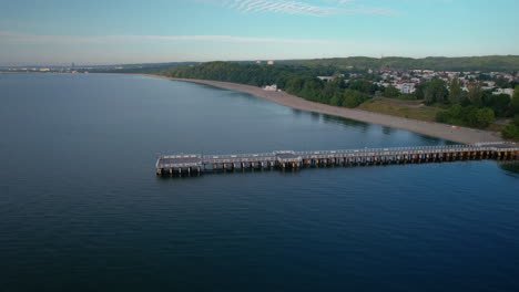 Famous-wooden-Gdynia-Orlowo-Pier-in-coastal-borough-of-Gdynia,-aerial-arc