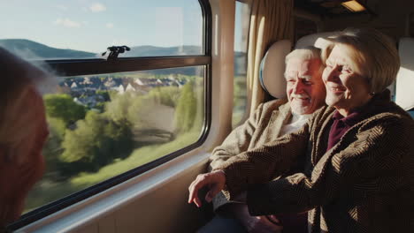 senior couple enjoying a train journey