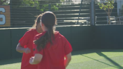 female soccer team warming up during training before match against flaring sun