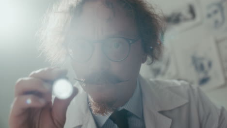 doctor shining flashlight at camera during medical exam at psychiatric hospital