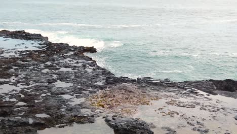 HD-Slow-motion-Hawaii-Kauai-static-center-frame-overlooking-Spouting-Horn-blowhole-going-off-full-frame,-part-one-of-two