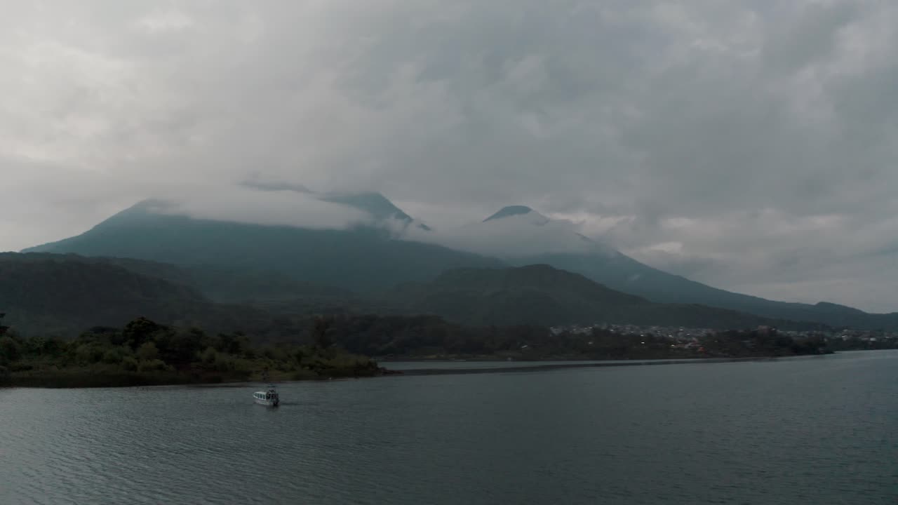 Passenger Boat On The Scenic Lake Atitlan In Guatemala During Sunrise - aerial orbit