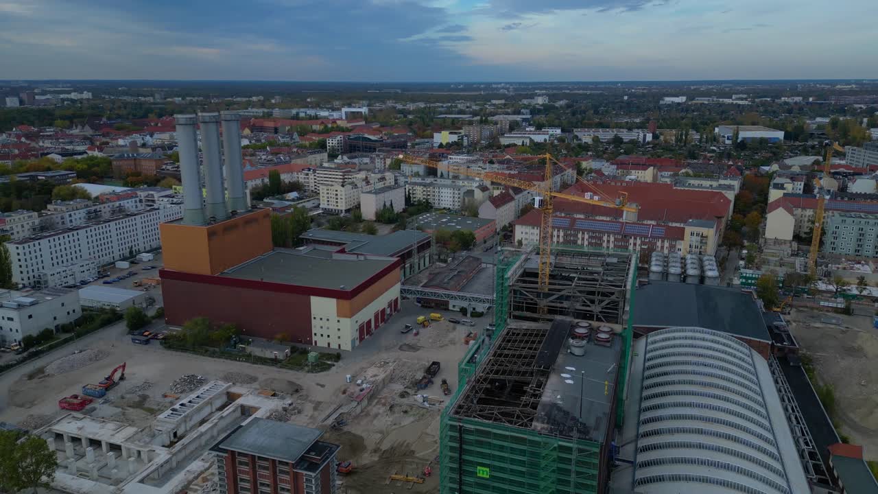 converted cogeneration Power plant , industrial buildings, and a large urban construction site. Tremendous aerial view flight tilt up drone