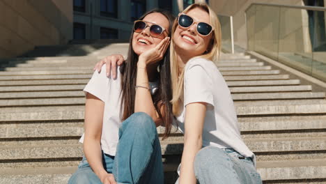 two women sitting on outdoor stairs