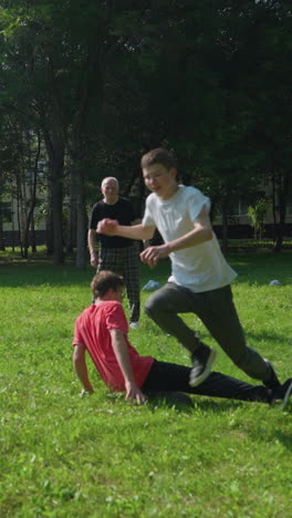 family enjoys a lively outdoor soccer game as both boys chase after the ball with determination while the brother in red kicks the ball across the grassy field on a sunny day