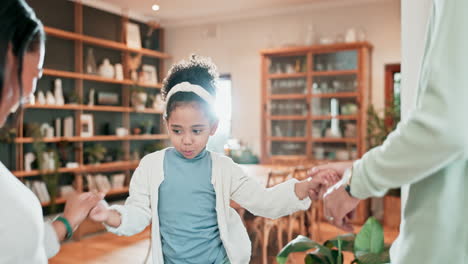 child, mother and father dancing in a family home