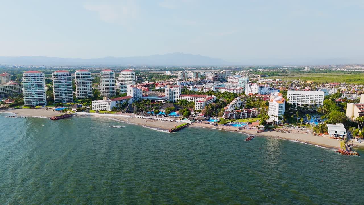 Luxury hotel zone in Marina Vallarta with sandy beaches. Mexican coastal city at sunset