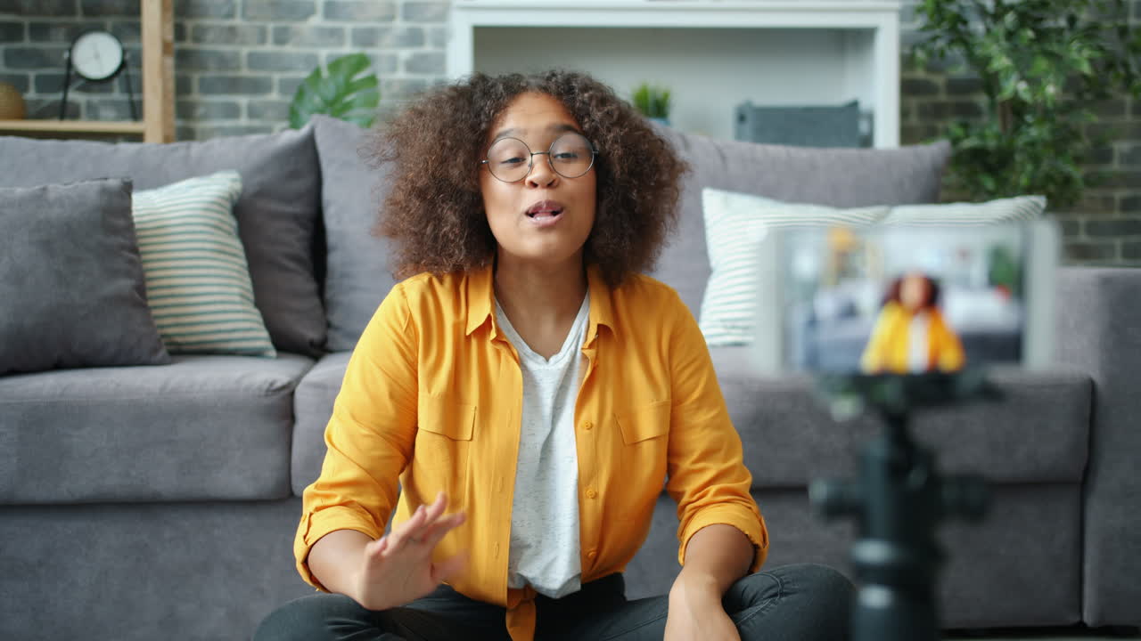 Young woman vlogging from her home