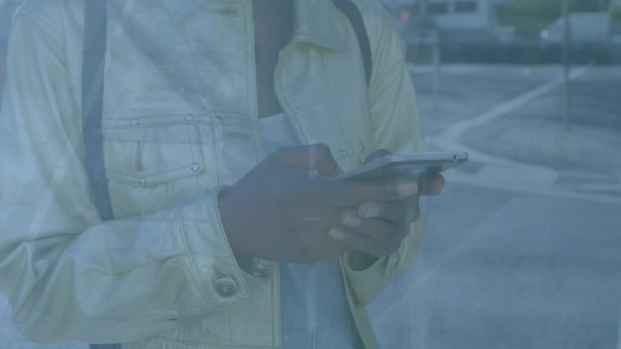 Person Using Smartphone on City Street