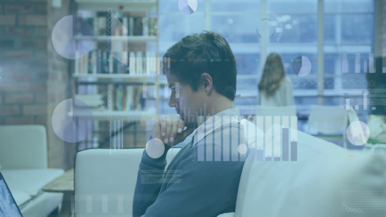 Animation of graphs and charts processing data over caucasian casual businessman using laptop