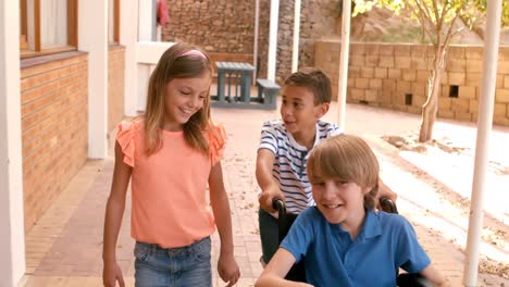 Schoolkids-carrying-disabled-friend-in-wheelchair