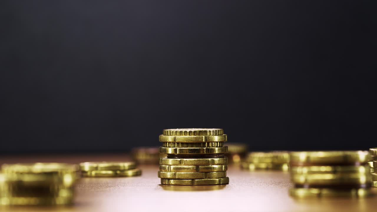 Animated coin stacks reduce one by one in stop motion, symbolizing money loss and decline