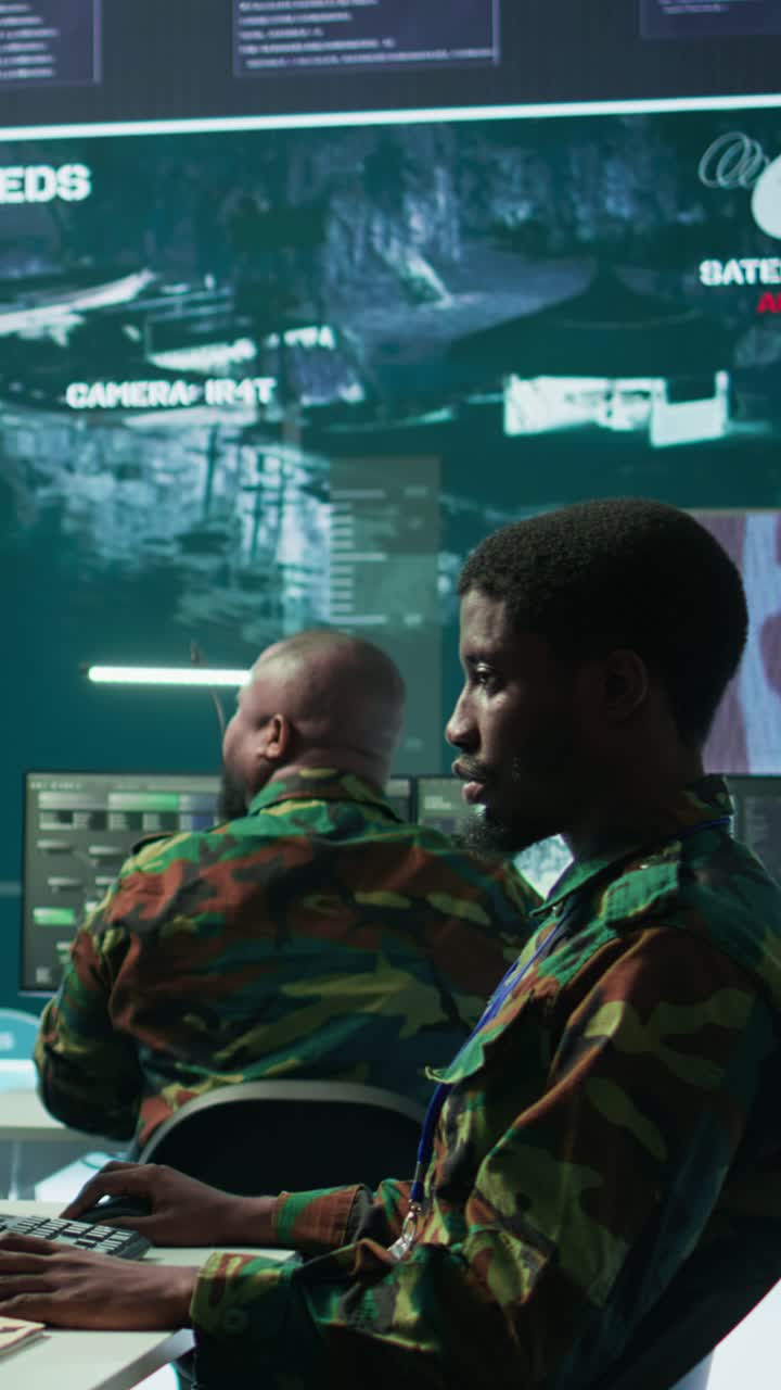 Vertical Video High tech military office with soldiers analyzing real time data