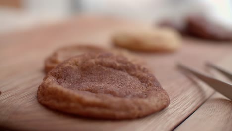 Tweezer-tongs-next-to-shallow-depth-of-field-rack-focus-over-sugar-cookies-in-cafe