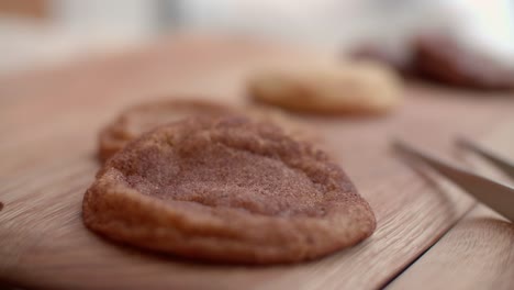 Tweezer tongs next to shallow depth of field rack focus over sugar cookies in cafe