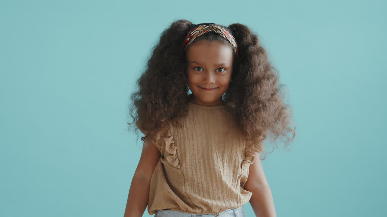 Happy Little Girl with Ponytails Posing