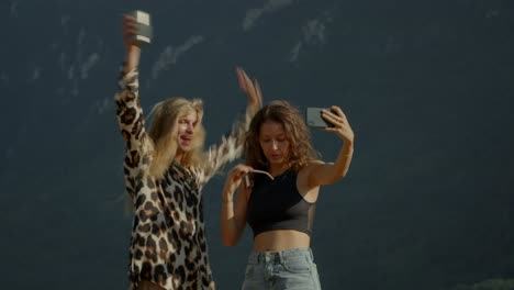 Two Friends Taking a Selfie in the Mountains