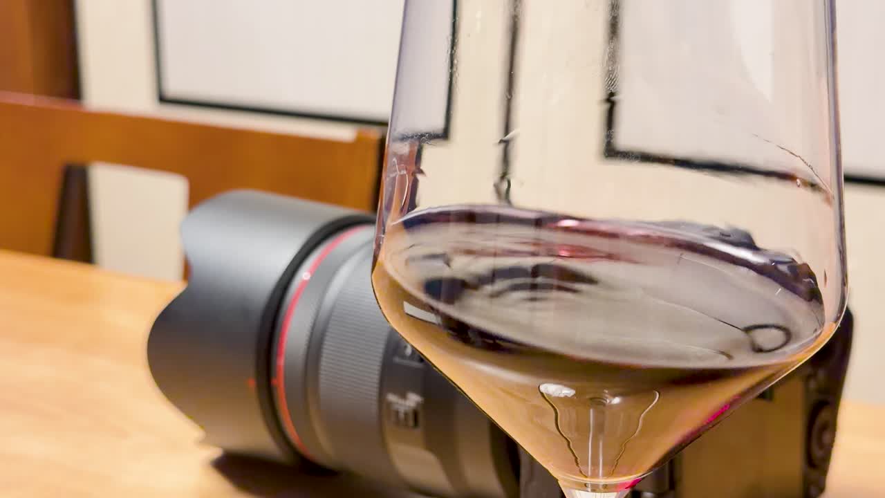 Close-up shot of red wine swirling inside a glass on a restaurant table in Kanazawa