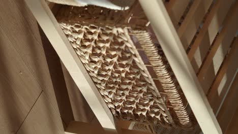 close-up of wooden chair with woven basket
