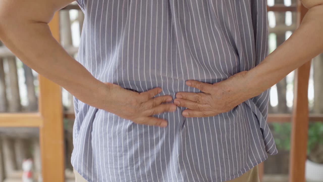 Close up of old woman hands grabing on hurt lower back