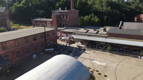 Vista-Lejana-De-Un-Lindo-Evento-Público-En-Un-Antiguo-Edificio-Industrial-De-Ladrillo-Rojo