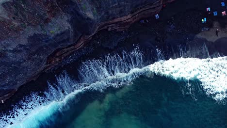 top view of waves fading smoothly on rocky beach, tenerife, spain