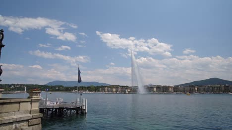 A-fountain-in-the-distance-on-a-river-in-Geneva,-Switzerland