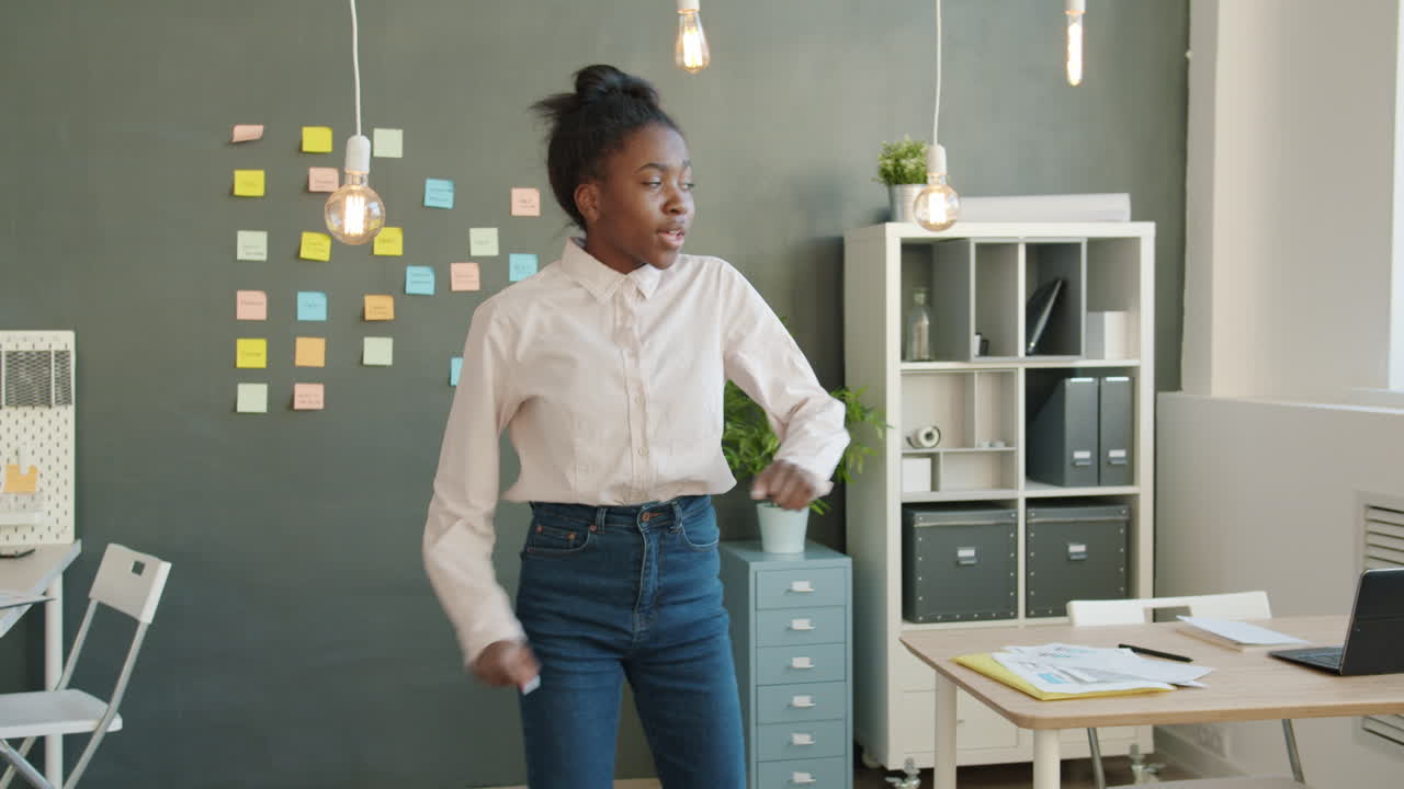 Young Woman Dancing in Modern Office