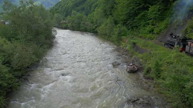 Aerial view of Mocanita, a narrow gauge railway, traversing the picturesque landscapes of the Vaser Valley in Romania