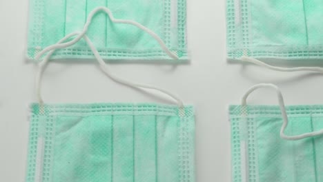 face surgical masks side by side displayed in pattern - overhead slide extreme close up