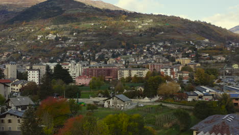 a majestic look of the valle d’aosta, italy, with amazing clave snow-capped mountains, and rooftops, a drone view