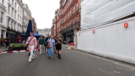 people walking on long acre, london street