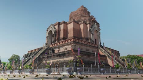 4k cinematic landscape footage of the buddhist temple monument of wat chedi luang in the old town of chiang mai, thailand on a sunny day