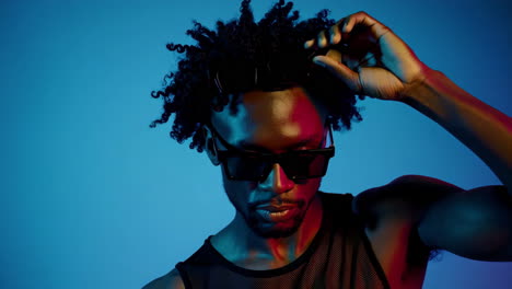 stylish man with sunglasses in neon light