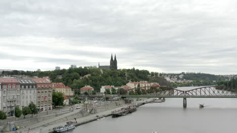 Fast-forward-aerial-of-bridge-over-Vltava-River-and-Vysehrad-Castle