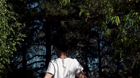 person stretching in a forest