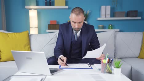 businessman working on charts at home.
