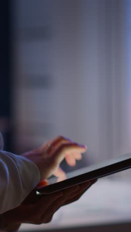 vertical video: close-up photo of woman hands typing on tablet
