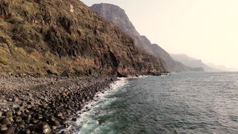 Idyllic-scene-of-two-people-at-unspoiled-virgin-beach-in-Gran-Canaria,-Spain-during-summer-time-on-vacations