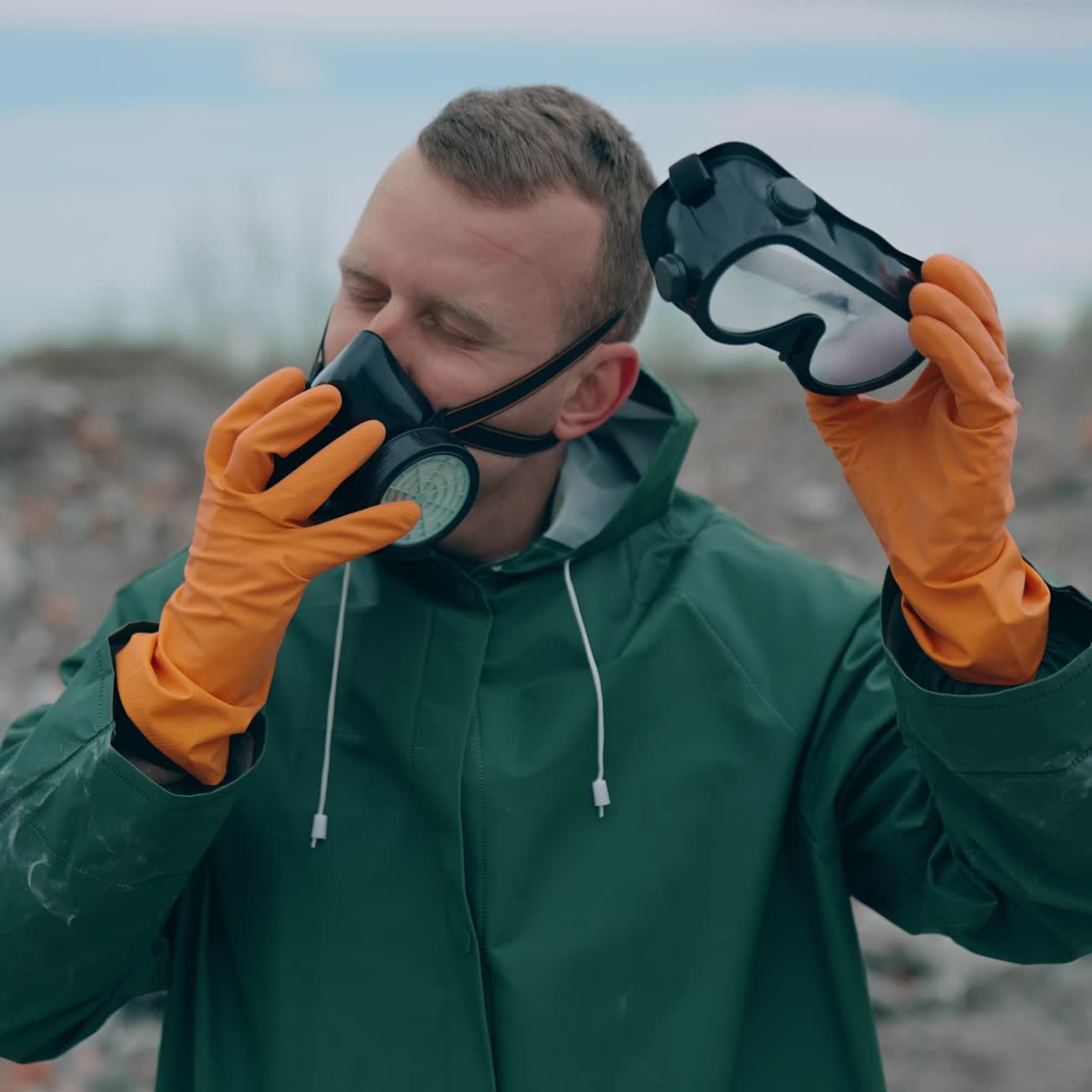 Apocalypse man with gas mask in ruins. Portrait of man in the gas masks and protective clothes on the ruined background