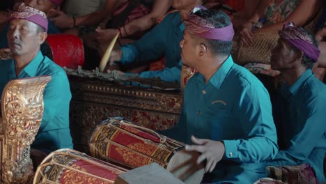 musicians play on kendang and metallophones instruments during legong traditional balinese theater dance performance at ubud palace, bali - close-up