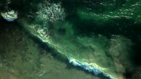 aerial view of waves crashing on the shore