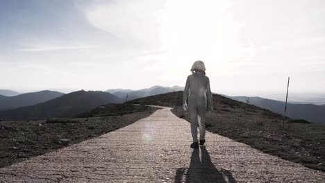 spaceman walking on path in countryside